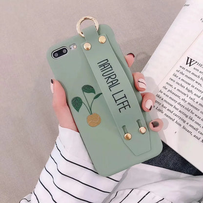 Green iPhone case with graffiti design and integrated wristband holder on back cover