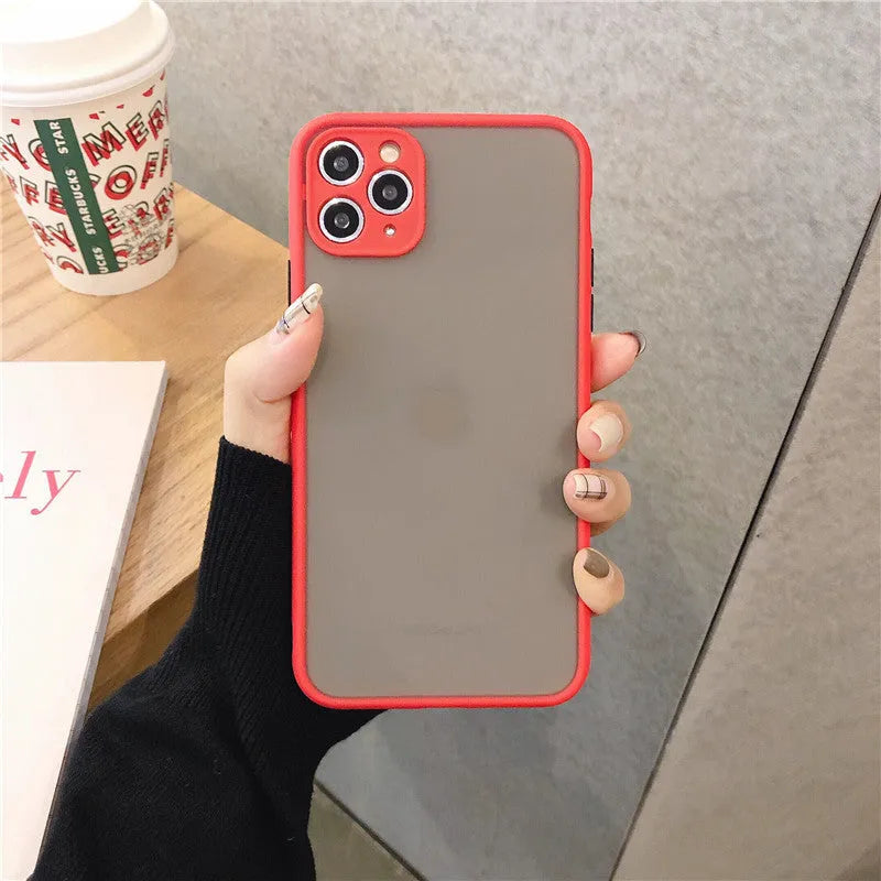 Solid colour silicone shockproof protective case for iPhone models on a table.