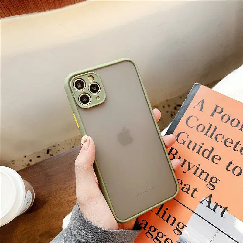 Solid colour silicone shockproof protective case for iPhone models on a table.