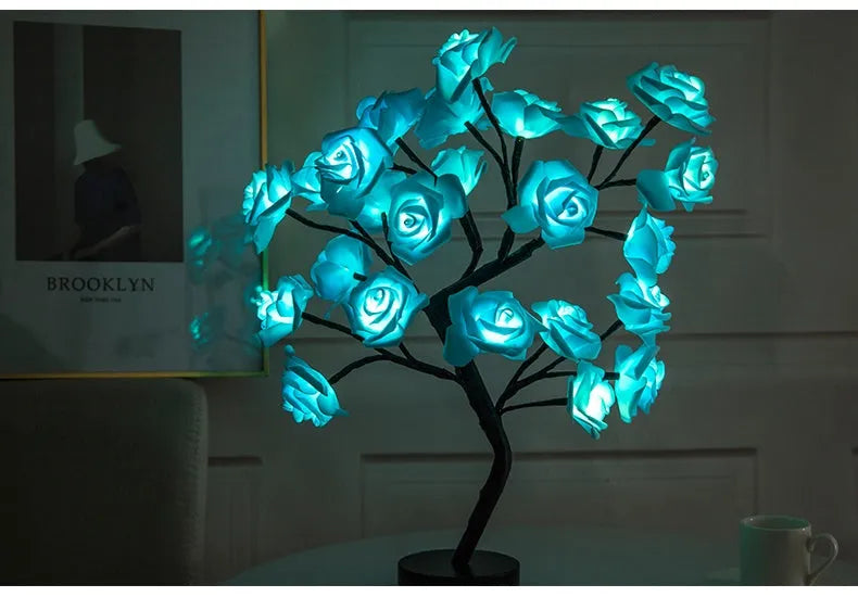 White and red rose flower LED lamp on a table with bonsai tree shape and warm white glow.