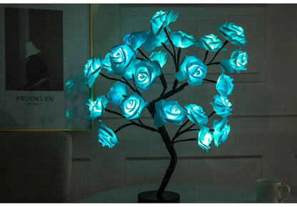 White and red rose flower LED lamp on a table with bonsai tree shape and warm white glow.