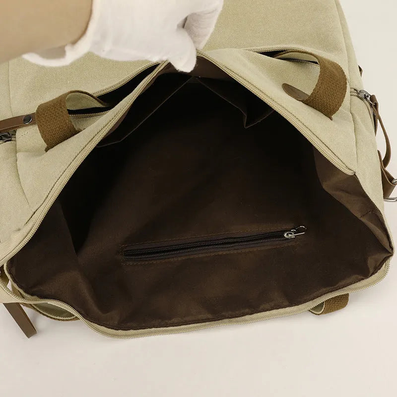 Large grey retro-style canvas shoulder bag with a horizontal square shape and multiple internal pockets.