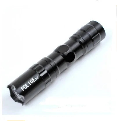Black aluminium mini LED flashlight shown next to a AA battery for scale.