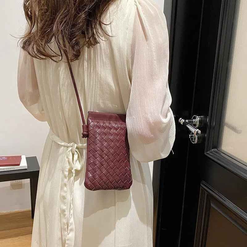 Vintage weave crossbody phone bag in pu leather showing vertical square design and dark cell interior