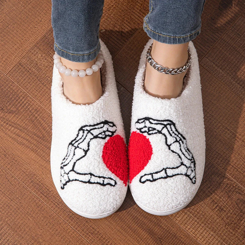Halloween-themed skull-hand slippers in black and white, featuring non-slip soles for indoor comfort.