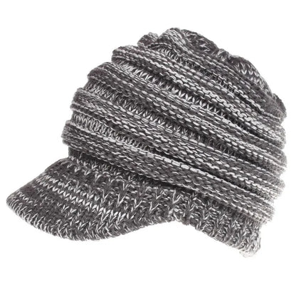 Women's acrylic knitted ponytail beanie in a solid colour, shown on a model with a ponytail.