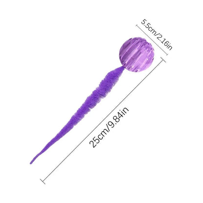 Green interactive cat toy with a bouncy ball and a long worm-shaped tail on a plain background.
