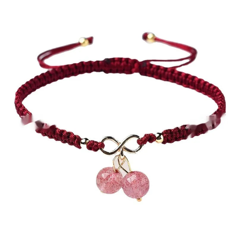 Women's adjustable bracelet with natural strawberry quartz cherry-shaped crystal charms on a chain.