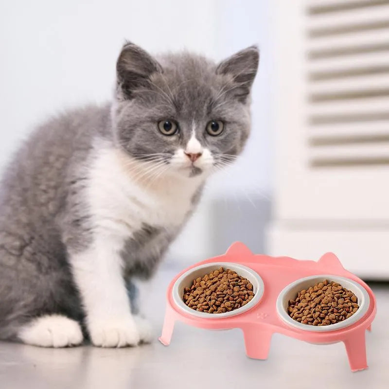 Ceramic cat food and water bowl set in elevated tilted stand, shown in blue, pink, white, and yellow colour options.