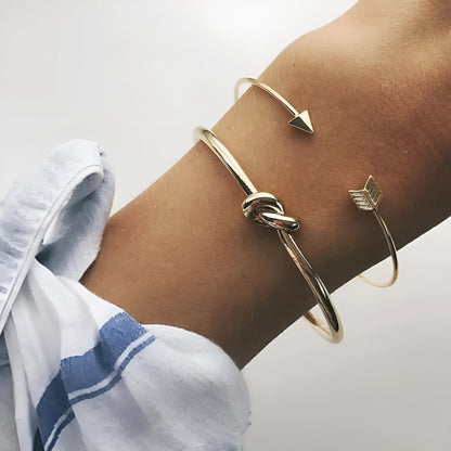 Gold-coloured vintage arrow knotted cuff bracelet for women.