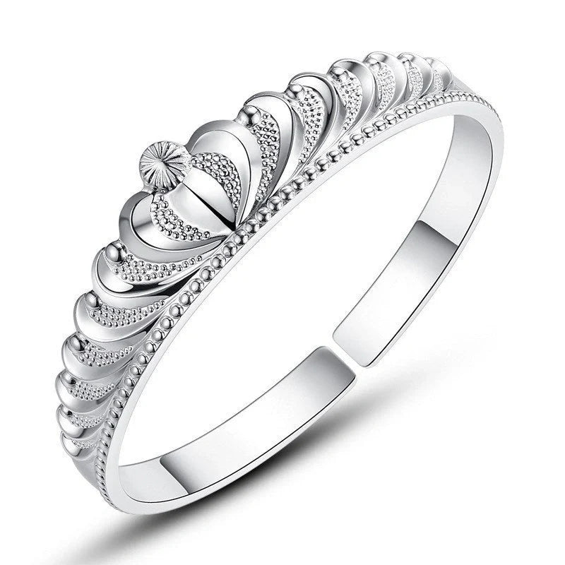 A close-up view of the elegant Crown Bracelet, showcasing its intricate crown-shaped design and shiny, rhodium-plated finish.
