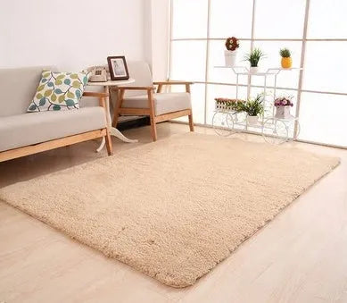 Solid colour plush rectangle area rug with soft texture on a wooden floor.