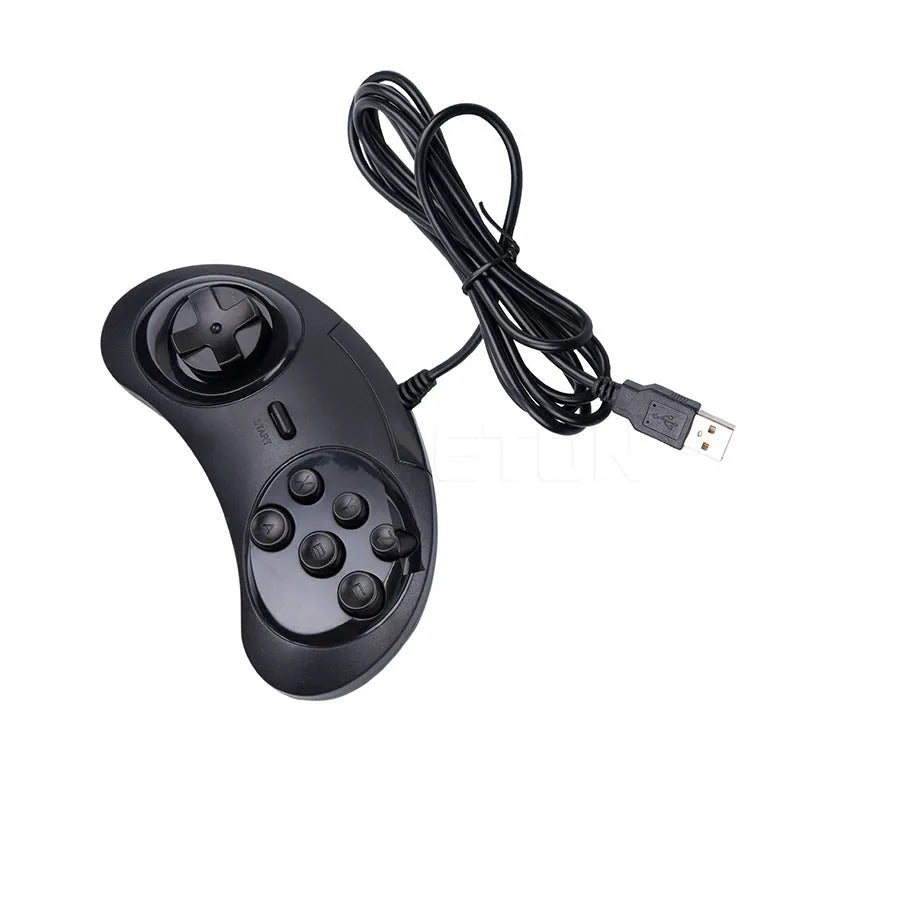 Black Sega USB PC game controller with 1.8m cable on a desk next to a laptop