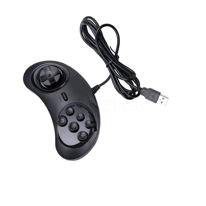 Black Sega USB PC game controller with 1.8m cable on a desk next to a laptop