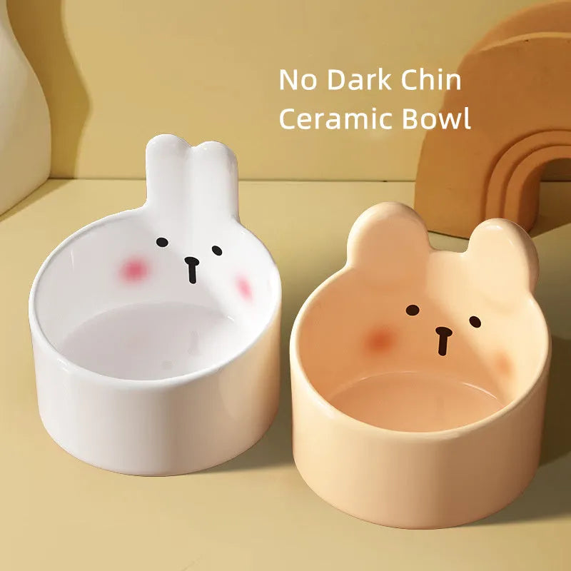 Blush Critter ceramic pet bowls in white rabbit and brown bear designs, showing neck protection rim.