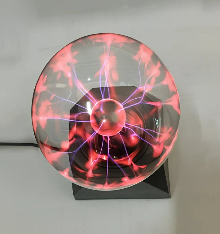 Plasma ball with colourful light arcs responding to finger touch on glass sphere