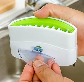 Blue multi-purpose kitchen brush with suction cup for cleaning utensils and vegetables
