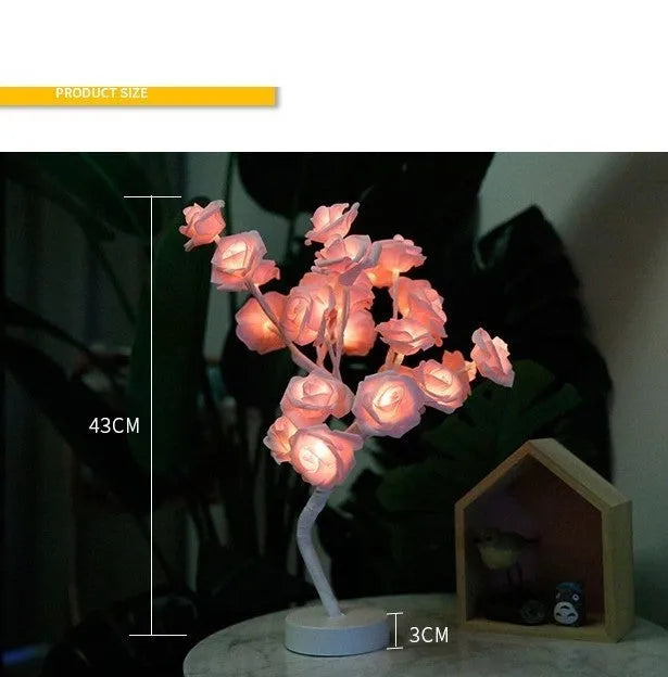 White and red rose flower LED lamp on a table with bonsai tree shape and warm white glow.