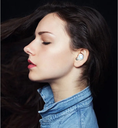 Black and white M18 true wireless in-ear headphones with a small rectangular charging case.