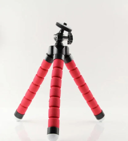 Black flexible octopus tripod with legs wrapped around a pole, holding a smartphone with a clip mount.