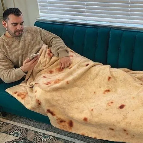 Round flannel burrito blanket with food-themed printing, showing coral fleece texture and wrap-style design