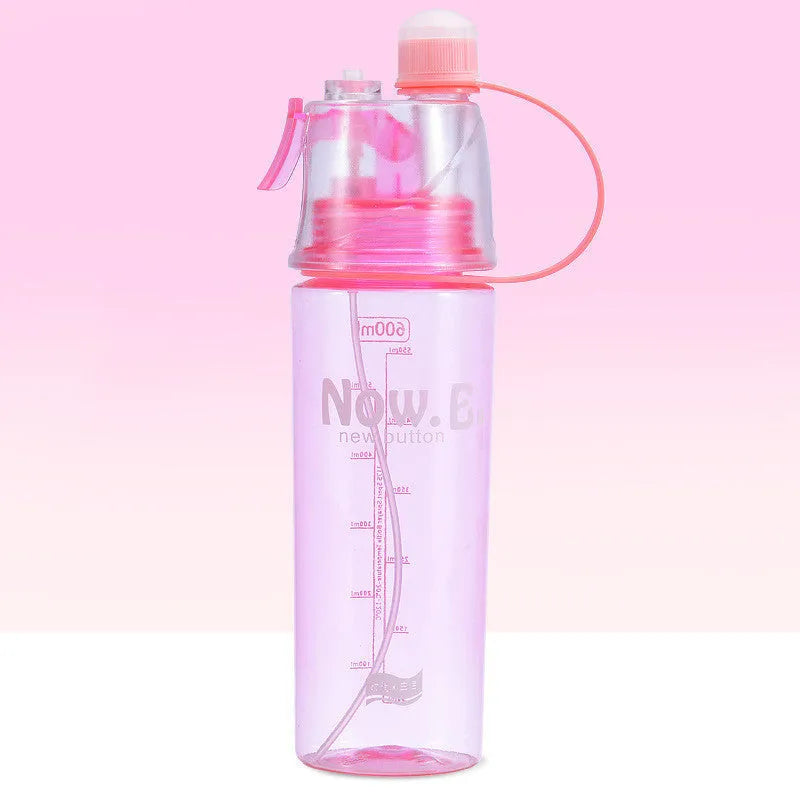 Green mist spray water bottle with clear volume scale and leakproof lid on a wooden table.