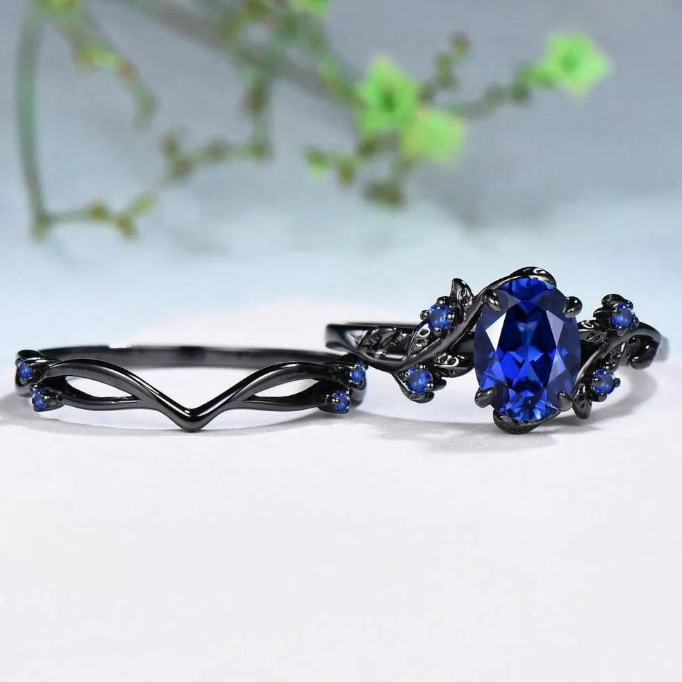 Geometric black women's couple ring with navy blue rhinestone inlay showing side profile