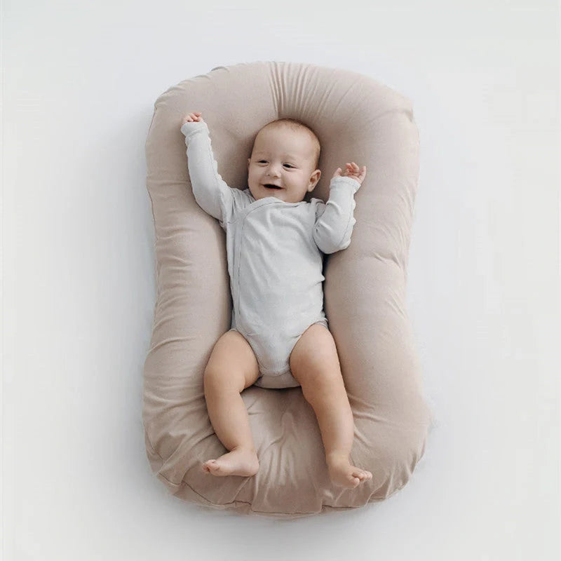 Portable baby nest crib in various colours, perfect for newborns to 3 years