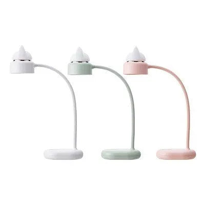 White clip-on LED desk lamp with built-in battery attached to a desk edge.