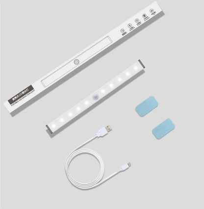 A matte aluminium LED closet light with a magnetic back, shown mounted inside a wooden wardrobe.