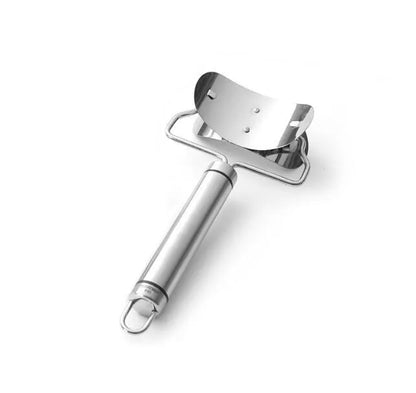 Stainless steel dumpling mould and rectangular dough cutter on a kitchen surface.