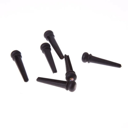 Six ebony folk guitar string nails with matte black finish and 5.3mm bayonet diameter