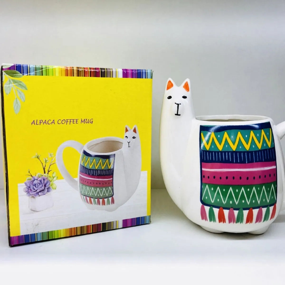 White ceramic mug with cartoon alpaca pattern and handle