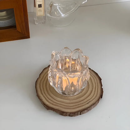 Transparent glass tulip candle holder with classic tumbler base on table