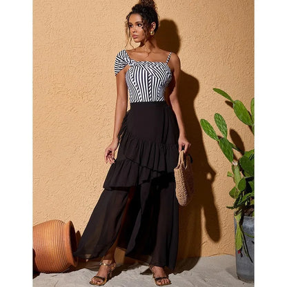 Women's striped one-piece swimsuit with ruffled design and black skirt overlay