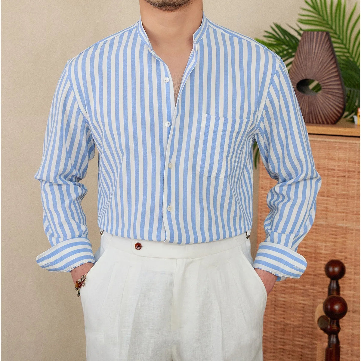 Blue and white seersucker striped long sleeve shirt with a loose lapel baseball collar.