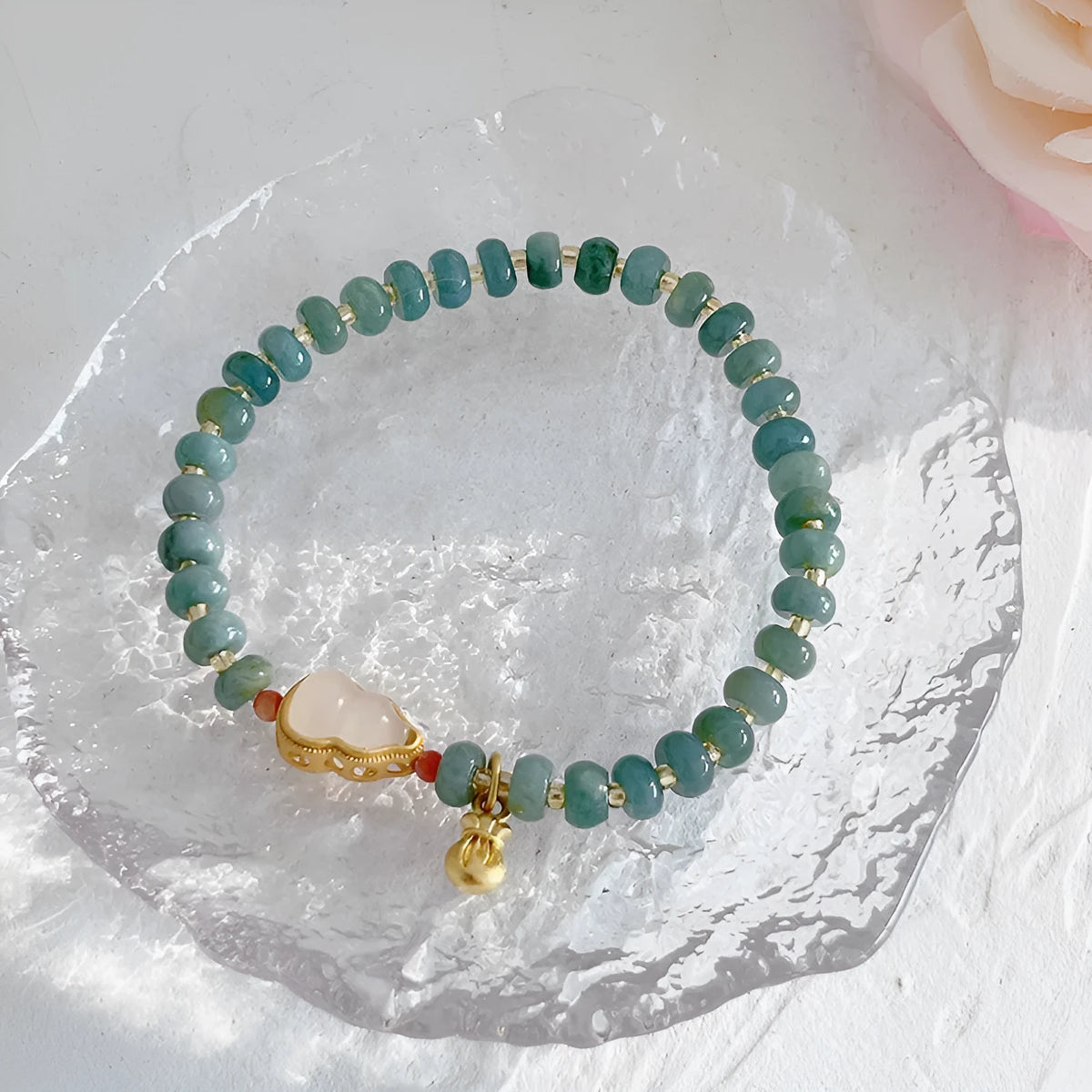 Simple blue jade bracelet with gourd charm, peace buckle, and adjustable cord on woman's wrist