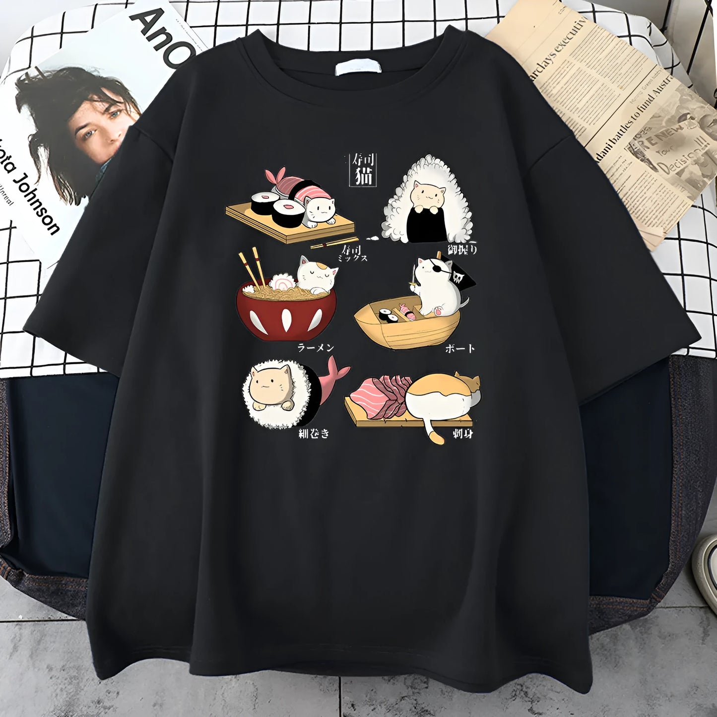 Man wearing a black loose-fit cotton t-shirt with a colourful cute cat sushi cartoon print on the front.