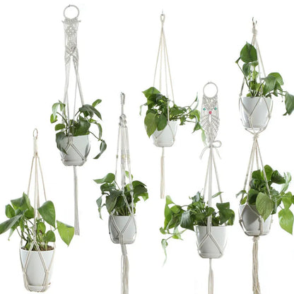 Handmade beige cotton rope net bag holding a plant pot, showing its textured sling design.