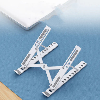 Black folding laptop stand bracket shown open at an angle and folded flat next to its storage bag.