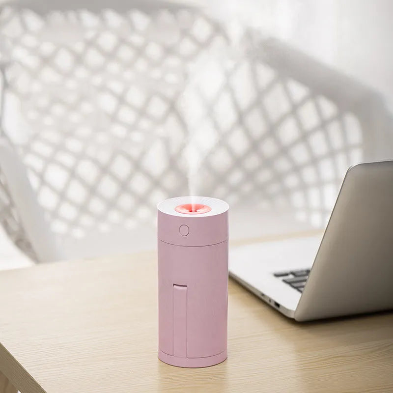 Folding bracket USB desktop humidifier for car and office use with 5V power, 320ml water tank capacity, 35-45ml/H spray volume, and choice of white, pink, or blue colour.