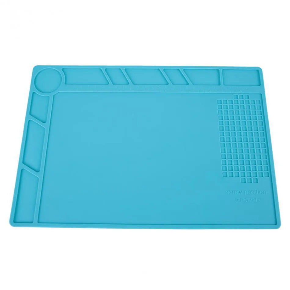 Blue silicone watch repair mat on workbench with watch tools