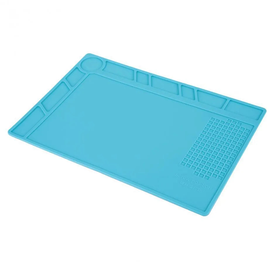 Blue silicone watch repair mat on workbench with watch tools