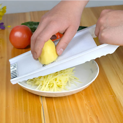 White five-piece stainless steel kitchen grater and vegetable slicer set with plastic hand guard