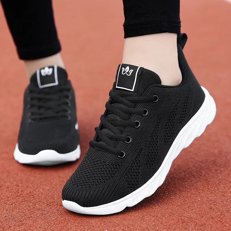 Women's white high-top trainers with cross-bind belt and hollow-out design on black background