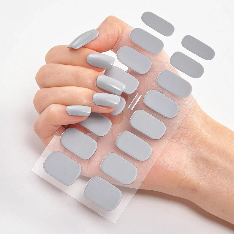 Nail art stickers with alphabet letters in sealed packaging, showing 16 designs per pack