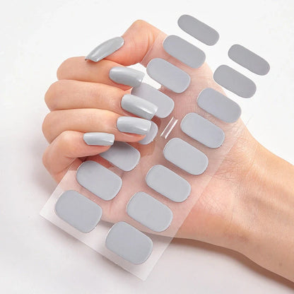 Nail art stickers with alphabet letters in sealed packaging, showing 16 designs per pack