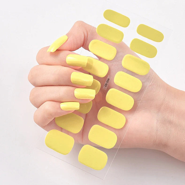 Nail art stickers with alphabet letters in sealed packaging, showing 16 designs per pack