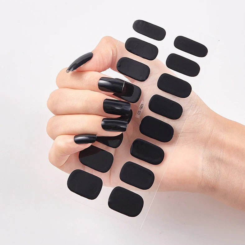 Nail art stickers with alphabet letters in sealed packaging, showing 16 designs per pack