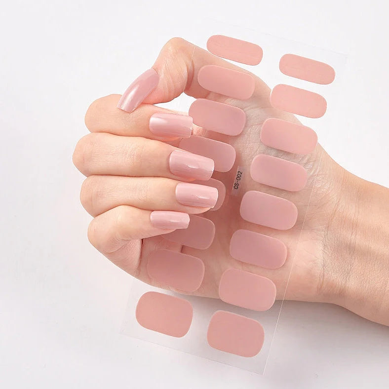 Nail art stickers with alphabet letters in sealed packaging, showing 16 designs per pack
